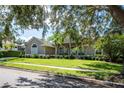 Well-maintained home with palm trees, tidy landscaping, and a well-kept green lawn at 2232 Lake Vilma Dr, Orlando, FL 32835