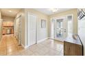 Bright foyer with tile flooring, closet, and front door with decorative glass at 2260 Winslow Cir, Casselberry, FL 32707