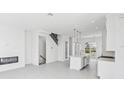 Open-concept living space boasts modern design with sleek fireplace and staircase at 2378 Addalia Aly, Orlando, FL 32804