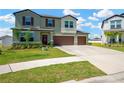 Charming two-story home with a lush green lawn and attached two-car garage at 2995 Flying Blackbird Rd, Bartow, FL 33830