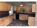This kitchen features ample wood cabinets, black appliances, and decorative tile backsplash at 3015 Avenue I Nw, Winter Haven, FL 33881
