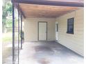 View of the covered patio and rear entrance of the home at 3015 Avenue I Nw, Winter Haven, FL 33881