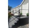 Charming front porch with painted steps, black railing, potted plants, and a welcoming entrance at 37518 Quail Ridge Cir, Leesburg, FL 34788