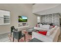 Spacious living room with high ceilings, a large sofa, and an entertainment center with a TV at 4772 Kings Castle Cir, Kissimmee, FL 34746
