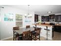 Cozy dining room with a stylish chandelier adjacent to the kitchen breakfast bar at 4793 Grassy Knoll Dr, Tavares, FL 32778