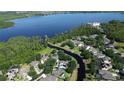 Aerial view of a waterfront neighborhood with lush greenery and clear blue water at 6350 Sedona Leaf Ct, Windermere, FL 34786