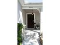 Inviting front door with decorative wreath, flanked by potted plants and lanterns on the front porch at 6350 Sedona Leaf Ct, Windermere, FL 34786