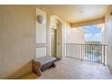 Condo balcony with a peaceful bench overlooking serene surroundings, creating a perfect outdoor relaxation spot at 7650 Comrow St # 403, Kissimmee, FL 34747