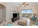 Inviting living room with a slider to balcony and a comfortable seating arrangement perfect for relaxing at 7650 Comrow St # 403, Kissimmee, FL 34747