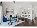 Bright living room featuring dark hardwood floors, a blue couch, and natural light at 774 Chelsea Dr, Davenport, FL 33897