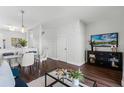 Open concept living room features dining area and access to the kitchen with hardwood floors at 774 Chelsea Dr, Davenport, FL 33897