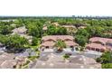 Community aerial view showcasing lush greenery, tile roofs, and ample parking at 7768 Sugar Bend Dr # 7768, Orlando, FL 32819