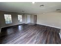 Open-concept living room featuring wood-style floors, a neutral palette, and bright natural light at 786 Crystal Bay Ln, Orlando, FL 32828