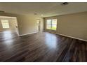 Spacious living room with modern hardwood floors, neutral walls, and bright natural light at 786 Crystal Bay Ln, Orlando, FL 32828