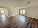 An open floorplan featuring new laminate wood flooring and ample lighting at 786 Crystal Bay Ln, Orlando, FL 32828