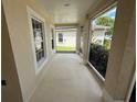 View of the enclosed front porch with neutral walls and views of the front yard at 786 Crystal Bay Ln, Orlando, FL 32828