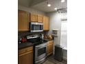 Modern kitchen showcasing stainless steel appliances, warm wood cabinetry, and stylish countertops at 8973 Lee Vista Blvd # 2308, Orlando, FL 32829