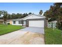 Attractive one-story home with a stone garage facade and lush front yard at 10140 Bridlewood Ave, Orlando, FL 32825