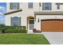 Charming two-story home with a well-maintained lawn, a two-car garage, and attractive architectural details at 1018 Boxelder Ave, Minneola, FL 34715
