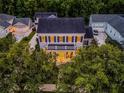Aerial view of a two-story home with a porch, complimented by surrounding trees and neighborhood at 1106 Celebration Ave, Celebration, FL 34747