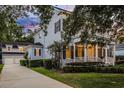 Charming home with a covered front porch, second story balcony, a long driveway, and detached garage at 1106 Celebration Ave, Celebration, FL 34747