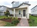 Charming front porch with brick walkway, complemented by lush landscaping and a cozy, inviting ambiance at 12272 Bracco St, Winter Garden, FL 34787