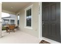 Welcoming front porch offers an outdoor dining area, perfect for enjoying the pleasant neighborhood views at 12272 Bracco St, Winter Garden, FL 34787