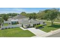 Bright home featuring a manicured lawn, privacy fence, and an extra outdoor building on a spacious lot at 1325 Mcneil Rd, Altamonte Springs, FL 32714