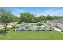 Well-maintained lawn and fenced yard featuring an additional outdoor building and patio area, with some solar panels at 1325 Mcneil Rd, Altamonte Springs, FL 32714