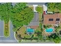 An aerial view displays a home with a pool, lush greenery, and a well-maintained neighborhood at 1440 Suzanne Way, Longwood, FL 32779