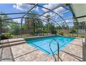 Inviting screened-in pool area features brick pavers and clear blue water, perfect for outdoor relaxation at 1440 Suzanne Way, Longwood, FL 32779