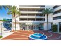 Welcoming building entrance with tiled fountain and palm trees at 150 E Robinson St # 2807, Orlando, FL 32801