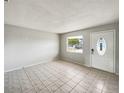 Inviting room with neutral walls, tiled flooring and a bright window overlooking the neighborhood at 1543 Sarah St, Lake Wales, FL 33898