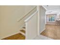 Bright staircase with wooden steps leads to the upper level at 1570 Barking Deer Cv, Casselberry, FL 32707