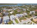 Aerial shot of a neighborhood with a mix of houses and lush greenery, nestled near a tranquil body of water at 1640 N Atlantic Ave, New Smyrna Beach, FL 32169