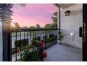 Balcony view showing colorful plants, clear furniture, and peaceful view at 200 Carolina Ave # 201, Winter Park, FL 32789
