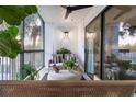 Cozy outdoor balcony with seating, ceiling fan, sliding glass doors and lovely plants at 200 Carolina Ave # 201, Winter Park, FL 32789