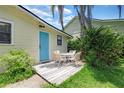 Cozy back patio with a white outdoor seating set and a vibrant blue door at 200 W 27Th St, Sanford, FL 32773
