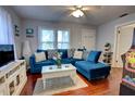 Inviting living room with a stylish blue sectional, hardwood floors, and ample natural light at 200 W 27Th St, Sanford, FL 32773