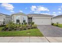 A well maintained home with a beautiful front garden and brick paver driveway at 2003 Spring Shower Cir, Kissimmee, FL 34744