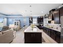 Open-concept kitchen with large island, stainless appliances, and modern countertops at 2003 Spring Shower Cir, Kissimmee, FL 34744