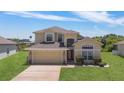 Inviting two-story home with manicured front lawn and charming architectural details at 2655 Star Lake View Dr, Kissimmee, FL 34747