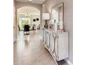 Inviting entryway with decorative console table, mirror, and an arched doorway at 3617 Fort Mellon Ln, Sanford, FL 32773