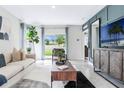 Cozy living room featuring a comfortable sofa, stylish coffee table, and sliding doors to the backyard at 3641 Fort Mellon Ln, Sanford, FL 32773