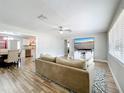 Open concept living room showcasing wood-look floors connecting to the dining and kitchen areas at 398 Rose St, Umatilla, FL 32784