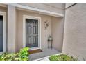 Inviting entryway featuring a dark front door, attractive decor, and a welcome mat at 5102 Monticello Heights Ln, Oviedo, FL 32765