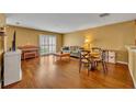 Spacious living room with hardwood floors, a large window, and comfortable seating arrangement at 5102 Monticello Heights Ln, Oviedo, FL 32765