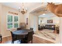 Open concept dining area with a round table, chandelier, and views into the spacious living room at 530 Heatheroak Cv, Altamonte Springs, FL 32714