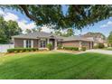 Inviting single-story home boasting a well-maintained lawn, mature trees, and a neutral color palette at 530 Heatheroak Cv, Altamonte Springs, FL 32714