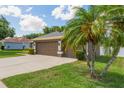 Attached two-car garage with mature palms and ample parking space on a sunny day at 530 Heatheroak Cv, Altamonte Springs, FL 32714